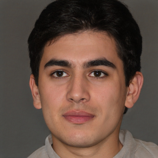 Joyful latino young-adult male with short  brown hair and brown eyes