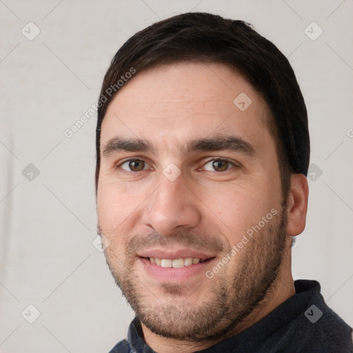 Joyful white young-adult male with short  black hair and brown eyes