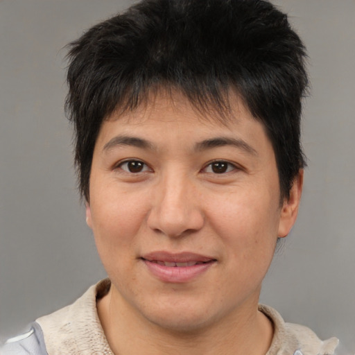 Joyful asian adult female with short  brown hair and brown eyes