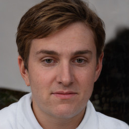 Joyful white adult male with short  brown hair and blue eyes