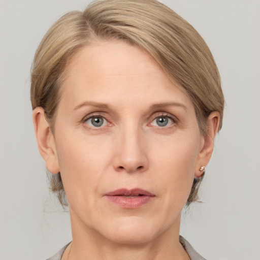 Joyful white adult female with medium  brown hair and grey eyes