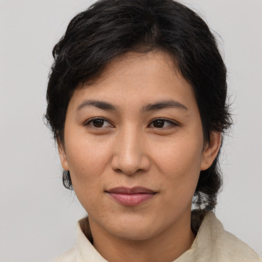 Joyful latino young-adult female with medium  brown hair and brown eyes