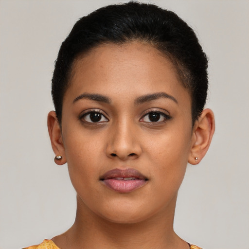 Joyful latino young-adult female with short  brown hair and brown eyes