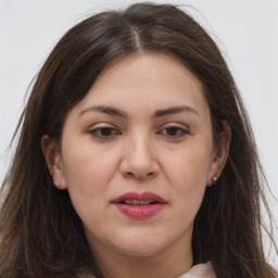 Joyful white adult female with long  brown hair and brown eyes