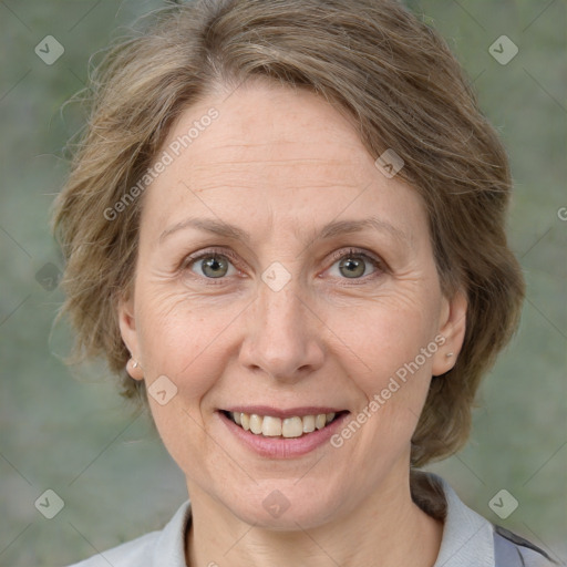 Joyful white adult female with medium  brown hair and grey eyes