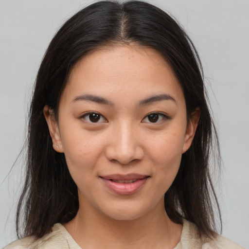 Joyful latino young-adult female with medium  brown hair and brown eyes