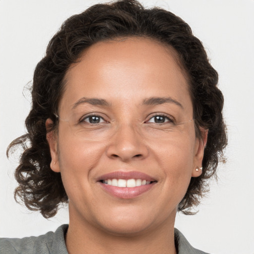 Joyful white adult female with medium  brown hair and brown eyes