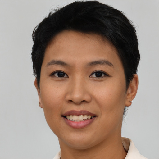 Joyful asian young-adult female with short  black hair and brown eyes