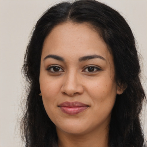 Joyful latino young-adult female with long  brown hair and brown eyes