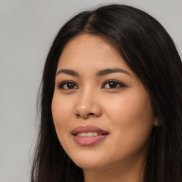 Joyful latino young-adult female with long  brown hair and brown eyes