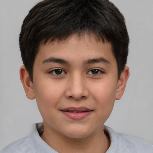 Joyful white child male with short  brown hair and brown eyes