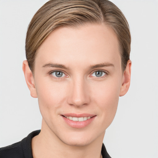 Joyful white young-adult female with short  brown hair and grey eyes