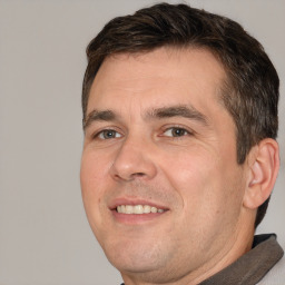 Joyful white adult male with short  brown hair and brown eyes