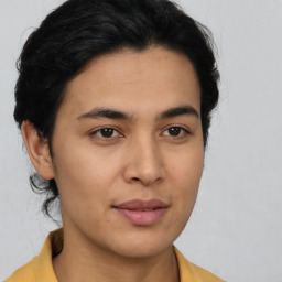 Joyful latino young-adult male with short  brown hair and brown eyes