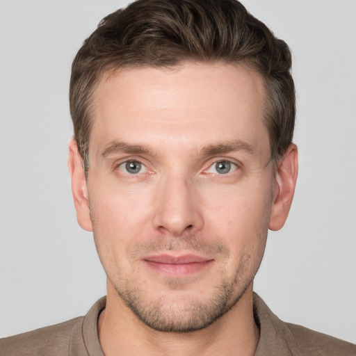 Joyful white adult male with short  brown hair and grey eyes