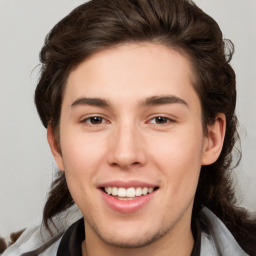 Joyful white young-adult male with medium  brown hair and brown eyes