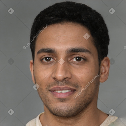 Joyful latino young-adult male with short  brown hair and brown eyes