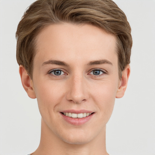 Joyful white young-adult female with short  brown hair and grey eyes