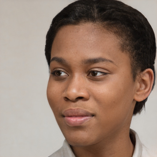 Joyful black young-adult female with short  brown hair and brown eyes