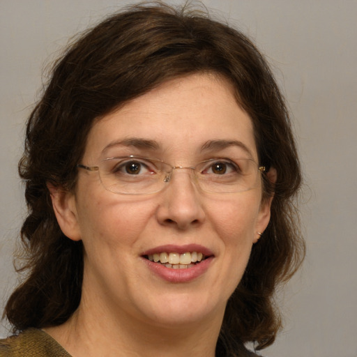 Joyful white adult female with medium  brown hair and green eyes