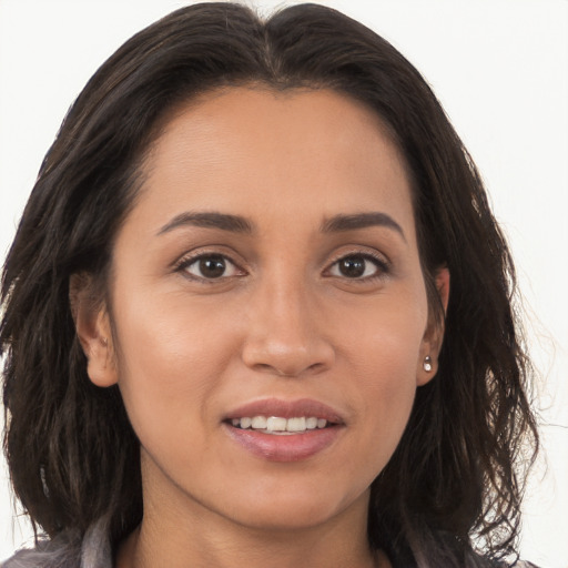 Joyful white young-adult female with long  brown hair and brown eyes