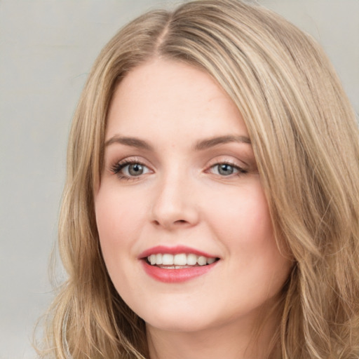 Joyful white young-adult female with long  brown hair and green eyes