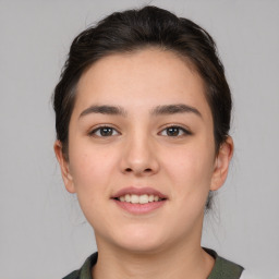 Joyful white young-adult female with medium  brown hair and brown eyes