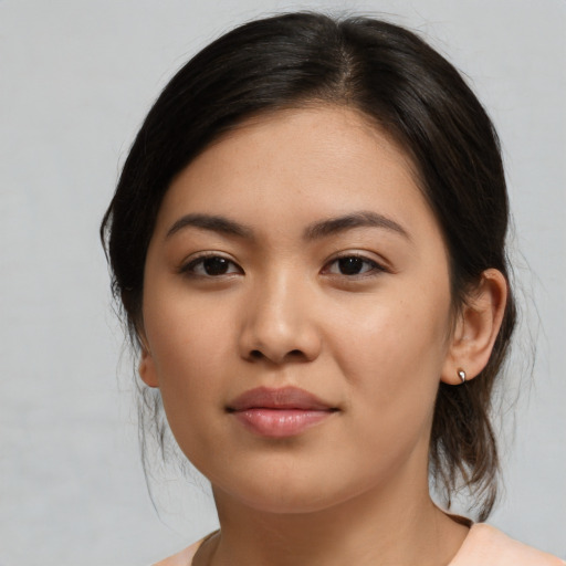 Joyful asian young-adult female with medium  brown hair and brown eyes