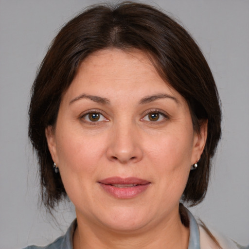 Joyful white adult female with medium  brown hair and brown eyes