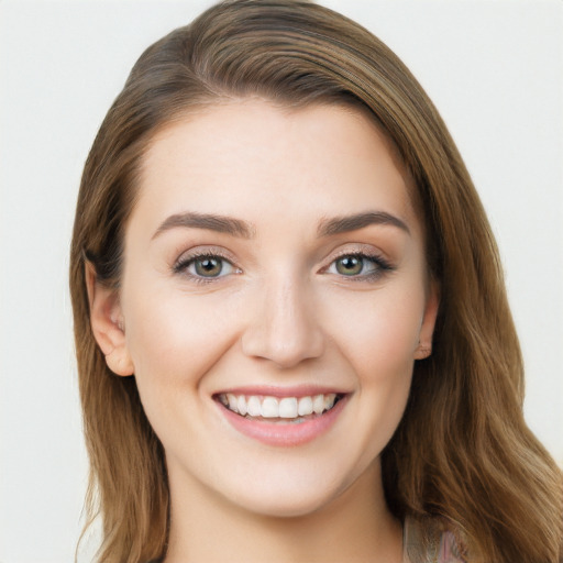 Joyful white young-adult female with long  brown hair and blue eyes