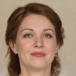 Joyful white adult female with medium  brown hair and grey eyes