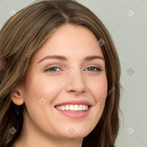 Joyful white young-adult female with long  brown hair and green eyes