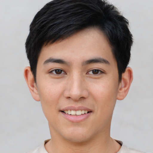 Joyful asian young-adult male with short  black hair and brown eyes