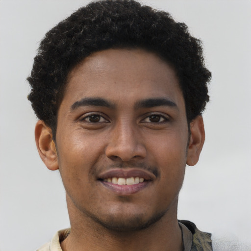 Joyful black young-adult male with short  brown hair and brown eyes