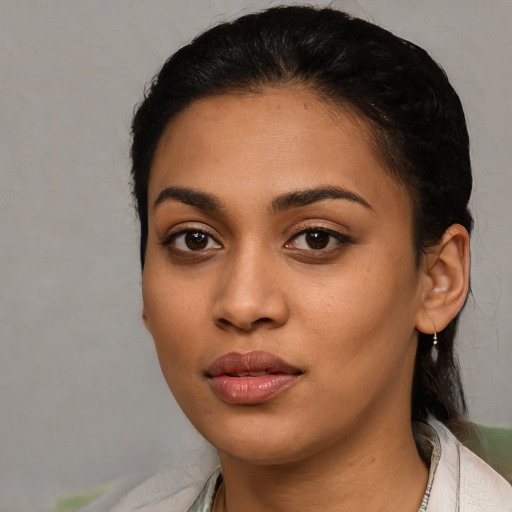 Joyful latino young-adult female with short  black hair and brown eyes