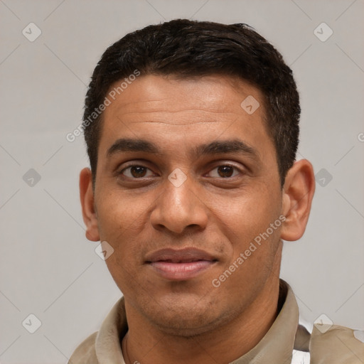 Joyful white young-adult male with short  black hair and brown eyes