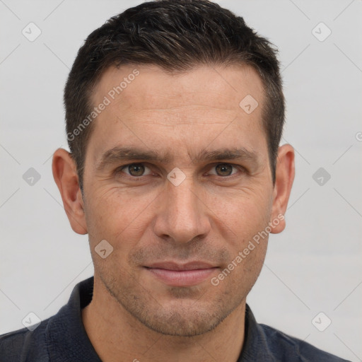 Joyful white adult male with short  brown hair and brown eyes