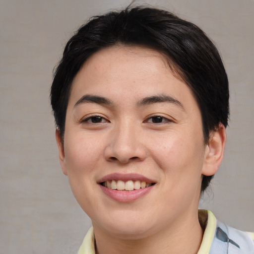 Joyful asian young-adult female with short  brown hair and brown eyes