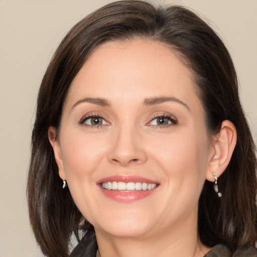 Joyful white adult female with medium  brown hair and brown eyes