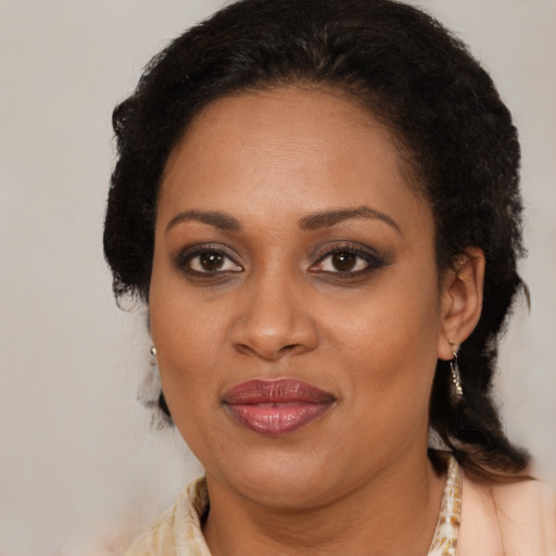 Joyful black adult female with medium  brown hair and brown eyes