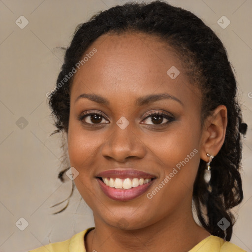 Joyful black young-adult female with long  brown hair and brown eyes