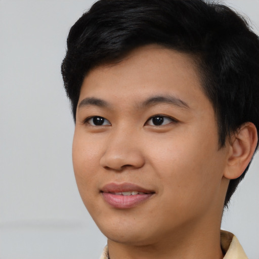 Joyful asian young-adult male with short  black hair and brown eyes