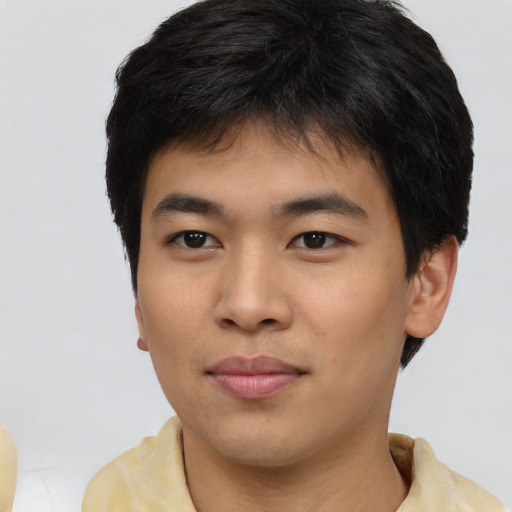 Joyful asian young-adult male with short  brown hair and brown eyes