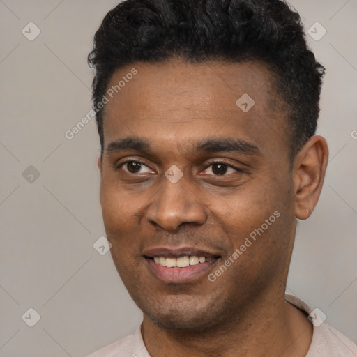 Joyful latino young-adult male with short  black hair and brown eyes