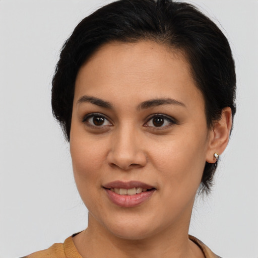 Joyful latino young-adult female with medium  brown hair and brown eyes
