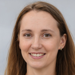 Joyful white adult female with long  brown hair and grey eyes