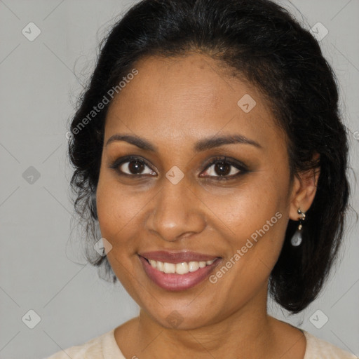 Joyful black adult female with medium  brown hair and brown eyes