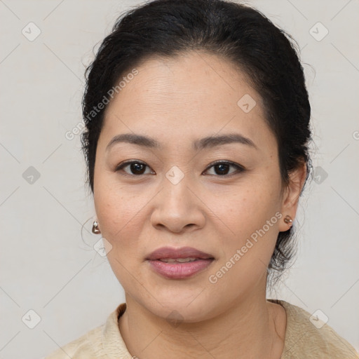 Joyful latino young-adult female with medium  brown hair and brown eyes