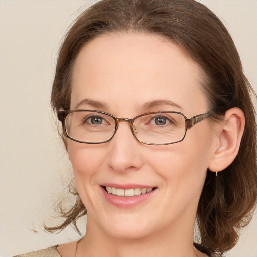 Joyful white adult female with medium  brown hair and blue eyes