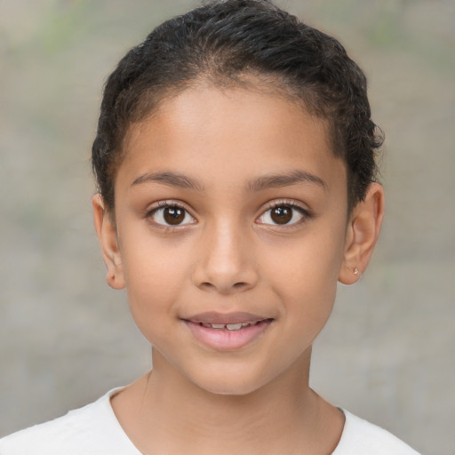 Joyful latino child female with short  brown hair and brown eyes